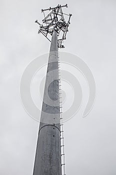 A cell phone tower on a cloudy day