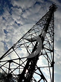 Cell phone tower and the cloudy sky