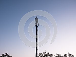 Cell phone tower / communications antenna or mast in silhouette at dusk