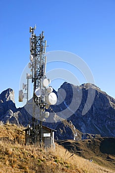 Cell phone tower in the Dolomites. Fall alpine landscape.
