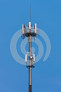 a cell phone tower on top of a building under a blue sky