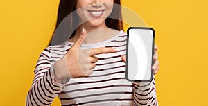 Cell phone with white empty screen in smiling lady hand