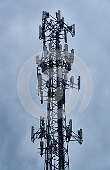 A cell tower against an overcast sky.