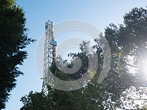 Cell tower / antenna mast in Porto, Portugal with lens flare on right from sun