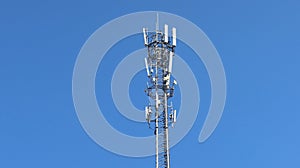 Cell tower antenna soars into blue sky