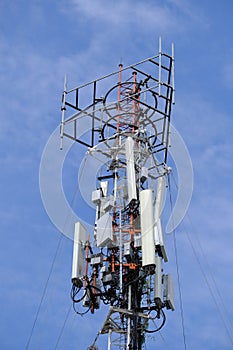 Cell tower antenna soars into blue sky