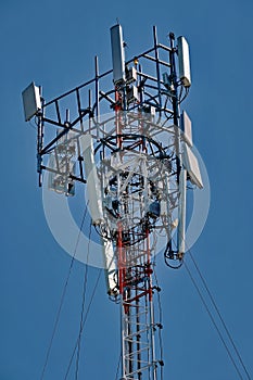 Cell tower antenna soars into blue sky