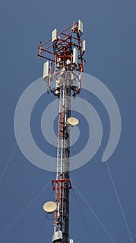 Cell tower antenna soars into blue sky