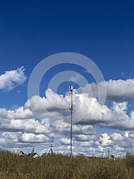 Cell tower on the background of clouds