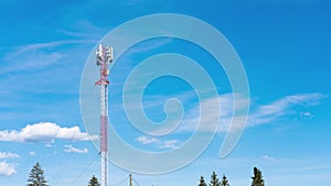 Cell tower with blue sky and cloud background. Time-lapse view over a beautiful blue sky and radio antenna tower