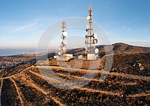 Cell tower. Cellular base station, mobile phone antenna aerial view. Rural island background