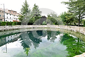 Cella fountain reflecting the trees of the park in the water photo