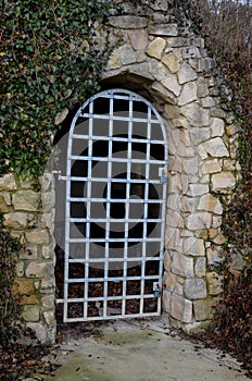 cellar door formed by a forged lattice in the shape of an arch.