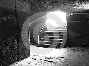 Cellar stairs of an old castle with sunbeams in black and white