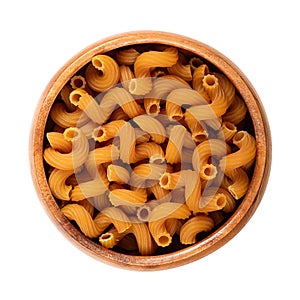 Cellentani or also cavatappi pasta, corkscrew shaped and gluten free, in wooden bowl