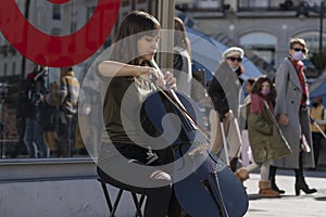 A cellist plays music in Puerta del Sol, Madrid, Spain