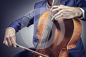 Cello player or cellist performing