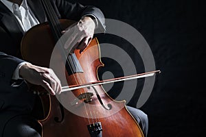 Cello player or cellist performing in an orchestra background photo
