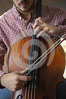 Cello playing cellist hands close up orchestra instruments