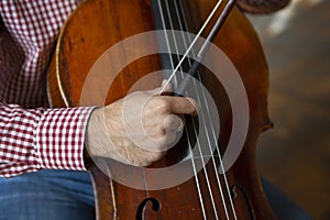 Cello playing cellist hands close up orchestra instruments