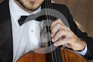 Cello playing cellist hands close up orchestra instruments