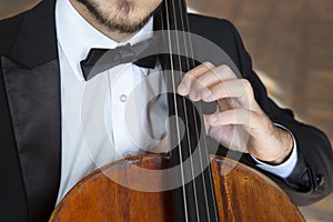 Cello playing cellist hands close up orchestra instruments