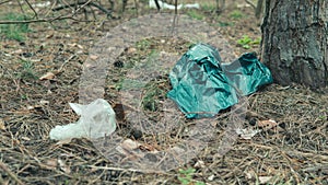 Cellophane bag on ground in forest. Concept of environmental pollution.