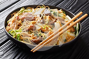 Cellophane Noodles cooked with pork belly, mushrooms and napa cabbage close-up in a plate. horizontal