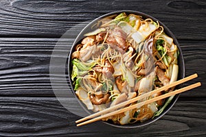 Cellophane Noodles cooked with pork belly, mushrooms and napa cabbage close-up in a plate. horizontal top view