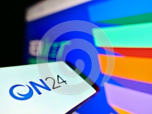 Cellphone with business logo of US webcasting and virtual content marketer ON24 Inc. on screen in front of website.