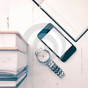 Cellphone with stack of book and watch vintage style