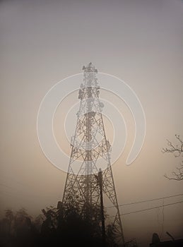 A Cellphone Tower view winter morning, foggy Background. Use To Transmit The Signal Of High Speed Mobile Internet
