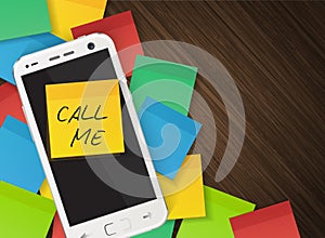 Cellphone and yellow reminder sticker with text call me