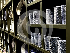 Ties and shirts for men on the shelves of a clothing store.