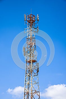 Cellular antenna against blue sky and the moon.