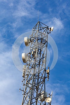 Cellular antenna on a background of blue sky in sunny weather