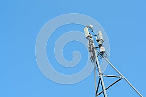 Cellular antenna on blue sky background,copyspace.