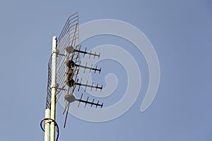 Cellular antenna on the roof of the building against the blue sky