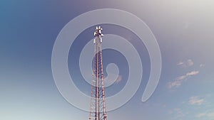 Cellular antenna tower and electronic radio transceiver equipment part of a cellular network under the blue sky. Radio transceiver