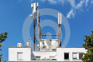 Cellular communication antennas on building roof.