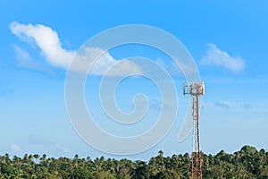Cellular mobile antenna on telecommunication tower in tropic climate atmosphere, copy space on blue sky background