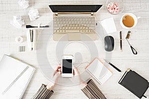 Cellular phone in the hand on the work place