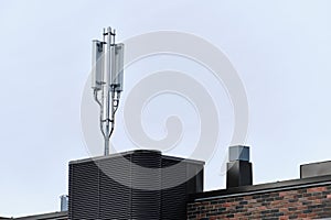 Cellular phone network telecommunication tower on the building roof