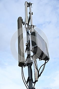 Cellular radio telecommunication network antenna mounted on a metal pole providing strong signal waves