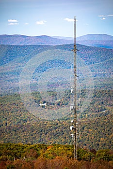 Cellular transmitting tower mounter in the forst hill at fall