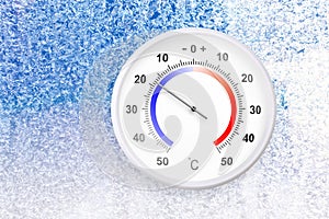 Celsius scale thermometer on a frozen window shows minus 18