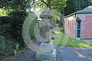 A Celtic Cross at the entrance to the graveyard in a village in Devon, United Kingdom