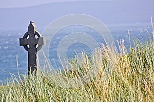 Celtic cross in a field in Inisheer, Ireland