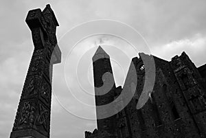 Celtic cross and the ruins of the gothic cathedral. Rock of Cashel. Tipperary county, Ireland