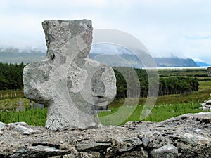 Celtic Stone Cross on top of stone wall